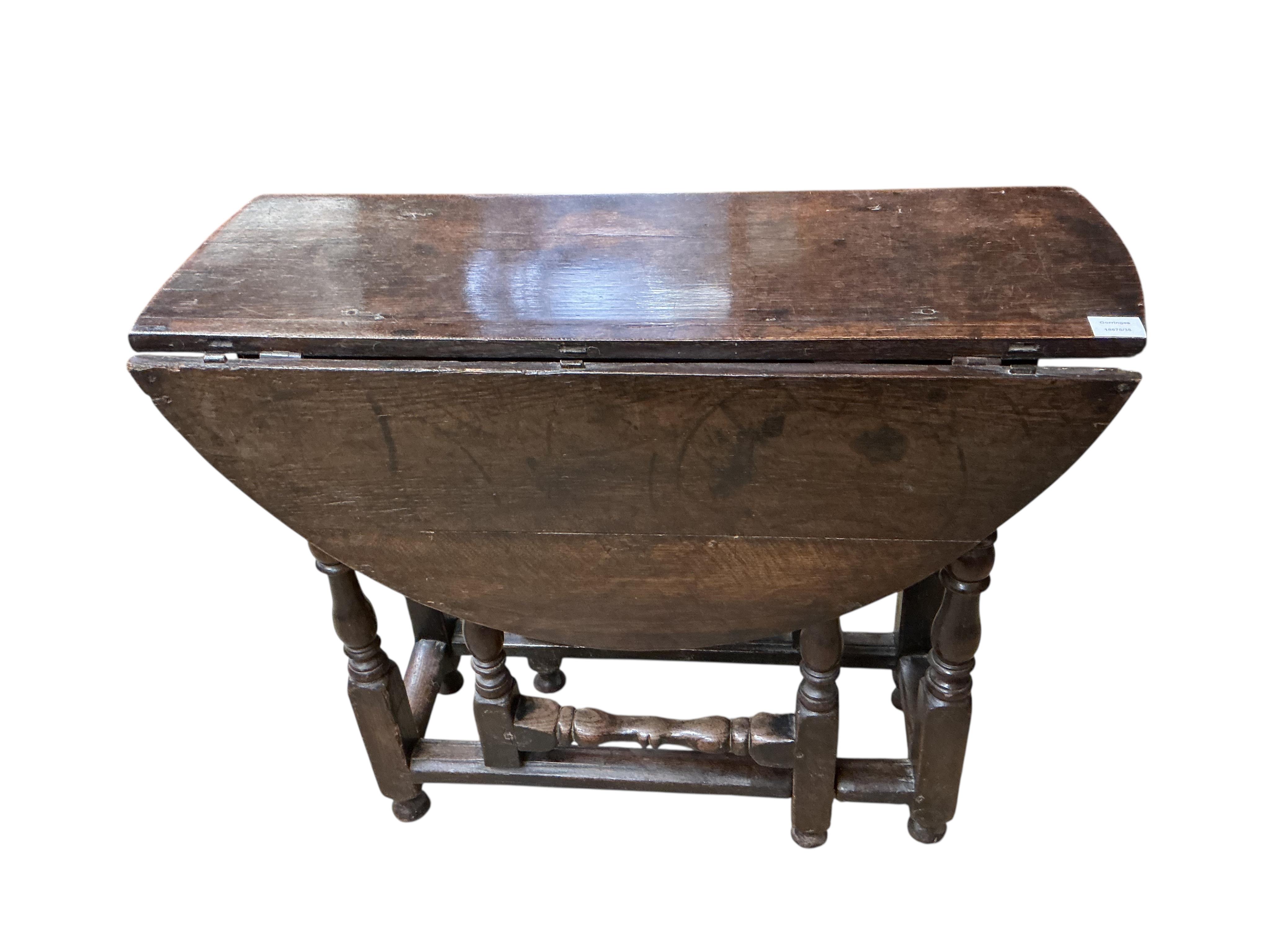 A small 18th century oval oak gate-legged table, width 92cm, depth 36cm, height 75cm